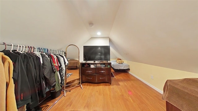 interior space featuring light wood-type flooring and lofted ceiling