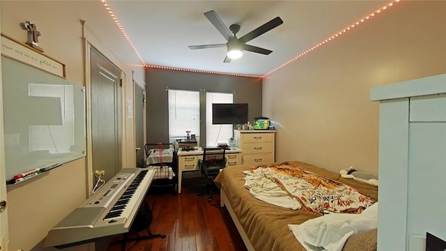 bedroom with ceiling fan, a closet, and dark wood-type flooring