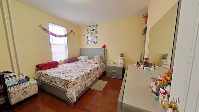 bedroom with dark hardwood / wood-style flooring