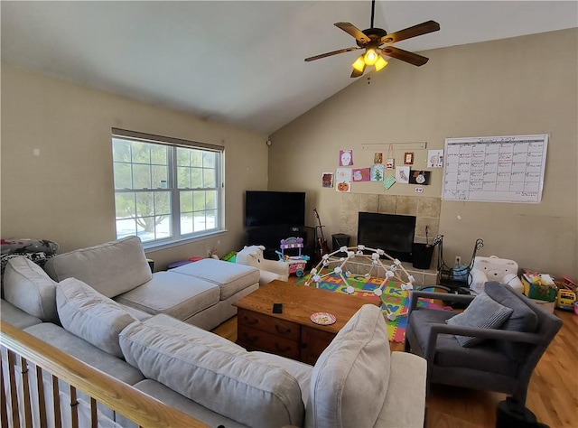 living room featuring a tile fireplace, ceiling fan, lofted ceiling, and hardwood / wood-style flooring