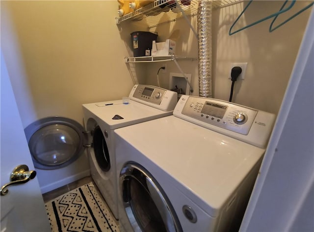 clothes washing area with washing machine and clothes dryer