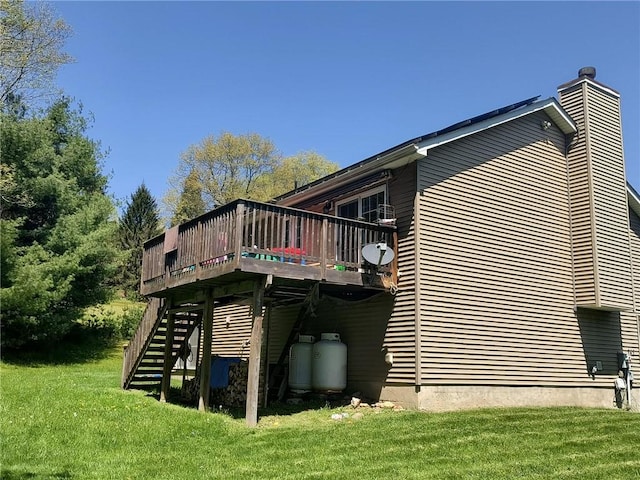 view of property exterior with a yard and a wooden deck