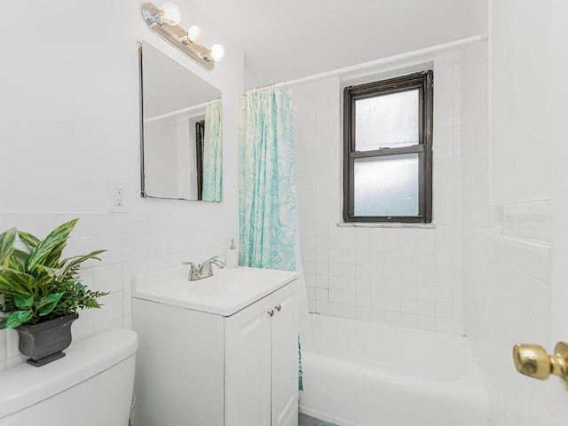 full bathroom featuring vanity, toilet, tile walls, and shower / bath combo with shower curtain