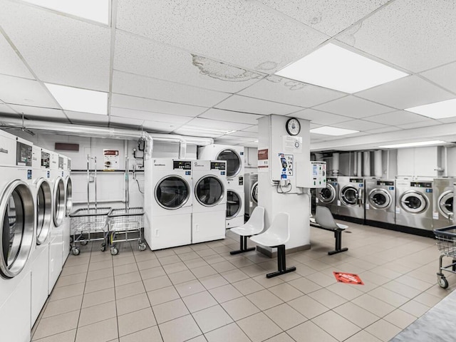 laundry area featuring light tile patterned floors and washing machine and clothes dryer