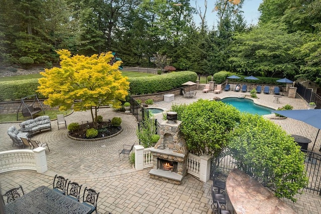 exterior space with an outdoor stone fireplace and a patio