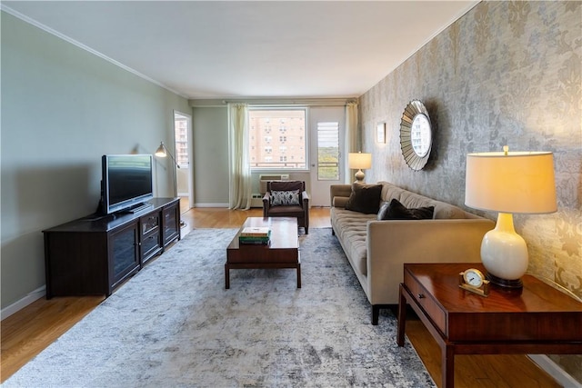 living room featuring wood-type flooring and ornamental molding