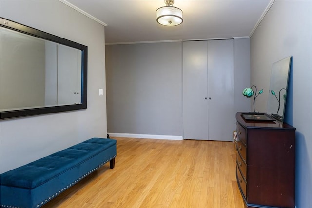 sitting room featuring light wood-type flooring and crown molding