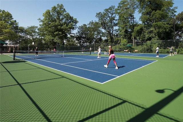 view of tennis court with basketball hoop