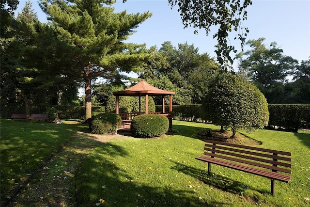 view of property's community with a gazebo and a yard