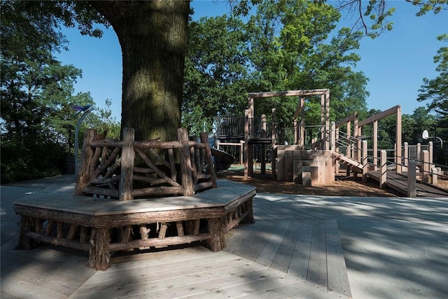 wooden deck featuring a playground