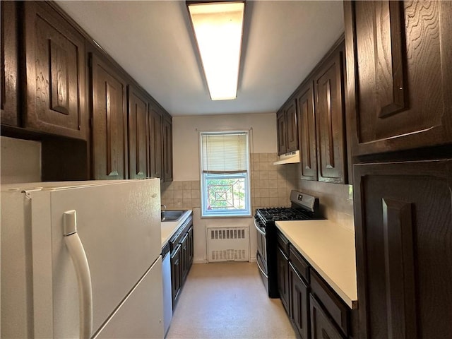 kitchen featuring radiator, decorative backsplash, dark brown cabinets, and stainless steel appliances