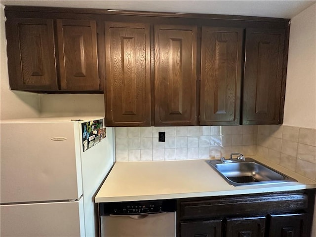 kitchen with dishwasher, white refrigerator, and dark brown cabinetry