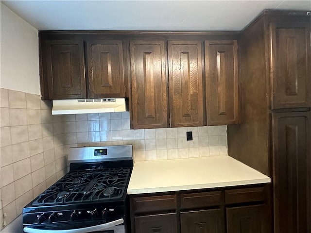 kitchen with backsplash, dark brown cabinets, and black gas range oven