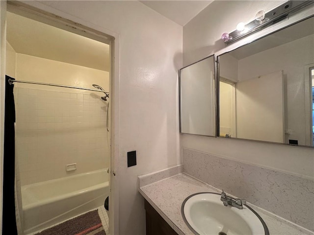 bathroom featuring tile patterned flooring, shower / tub combination, and vanity