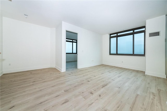 spare room featuring light hardwood / wood-style flooring