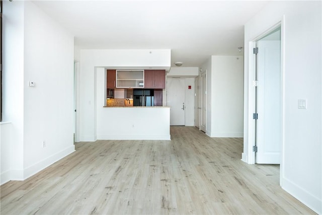 unfurnished living room with light hardwood / wood-style flooring