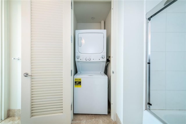 laundry room featuring stacked washer / drying machine