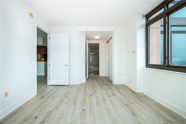 spare room with light hardwood / wood-style flooring