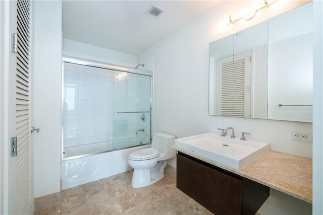 full bathroom featuring vanity, toilet, and enclosed tub / shower combo