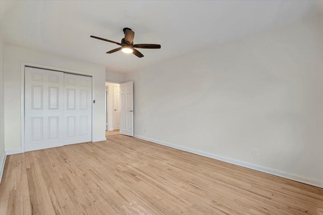 unfurnished bedroom featuring a closet, light hardwood / wood-style flooring, and ceiling fan