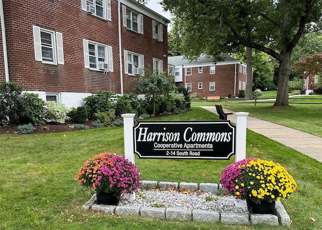 community / neighborhood sign with a yard