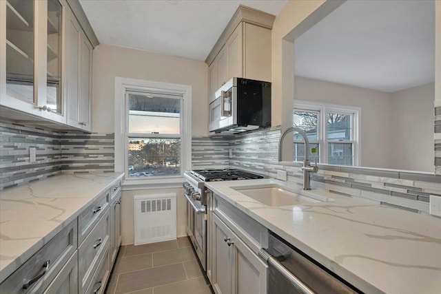 kitchen featuring decorative backsplash, stainless steel appliances, and a wealth of natural light