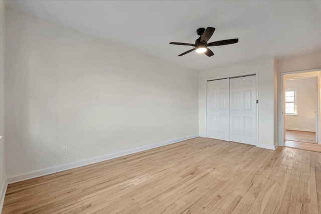 unfurnished bedroom with ceiling fan, a closet, and light wood-type flooring