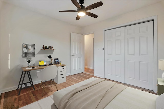 bedroom featuring ceiling fan, a closet, and wood-type flooring