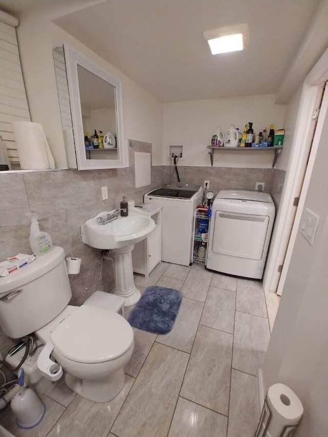 bathroom featuring backsplash, tile patterned floors, washer and clothes dryer, and toilet