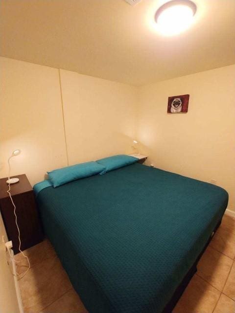 bedroom featuring tile patterned flooring