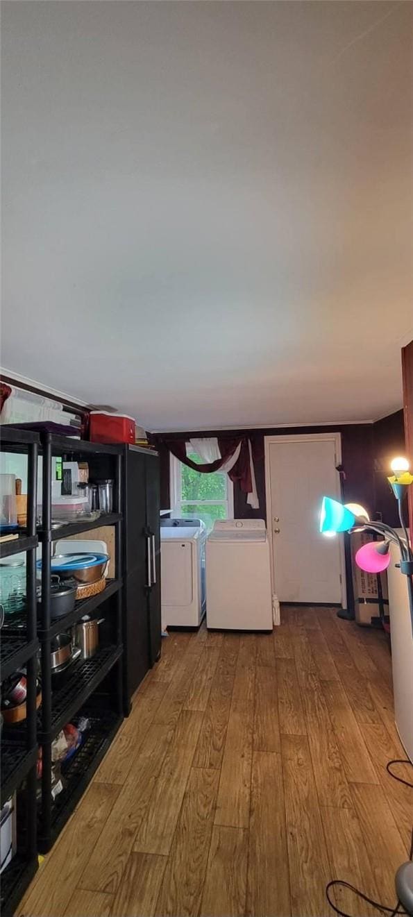 interior space with light hardwood / wood-style flooring and washing machine and clothes dryer