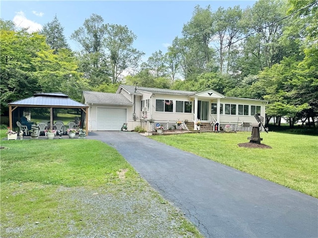 view of front of house featuring a front yard, a garage, a gazebo, aphalt driveway, and entry steps