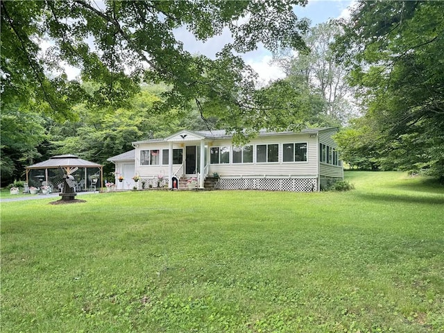 view of front of house with a gazebo, a sunroom, and a front lawn