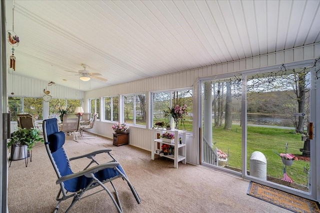 sunroom / solarium with ceiling fan and vaulted ceiling