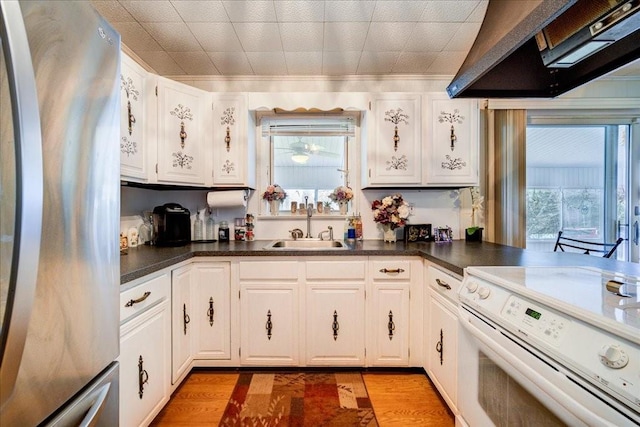 307 Beaver Lake Rd, Livingston Manor, NY 12758 - kitchen featuring freestanding refrigerator, electric range, ventilation hood, and white cabinets