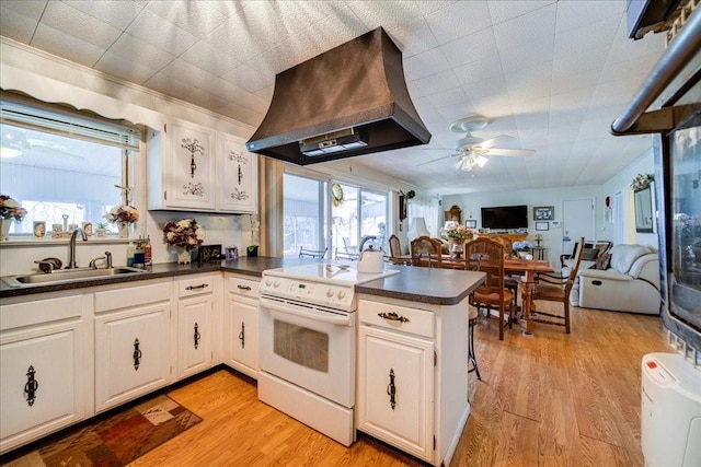 307 Beaver Lake Rd, Livingston Manor, NY 12758 - kitchen featuring electric range, custom range hood, a peninsula, ceiling fan, and dark countertops