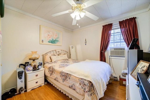 bedroom featuring hardwood / wood-style flooring, ceiling fan, cooling unit, and crown molding