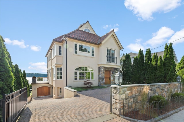 33 Livingston Ave, Dobbs Ferry, NY 10522 - mediterranean / spanish home featuring stucco siding, stone siding, a tiled roof, and decorative driveway