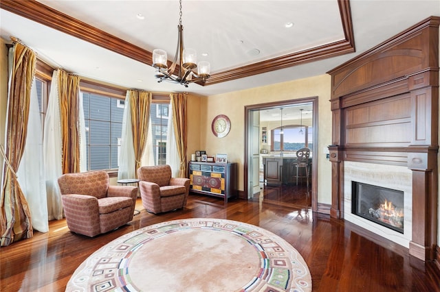 33 Livingston Ave, Dobbs Ferry, NY 10522 - sitting room featuring dark wood-style flooring, a chandelier, ornamental molding, a glass covered fireplace, and baseboards