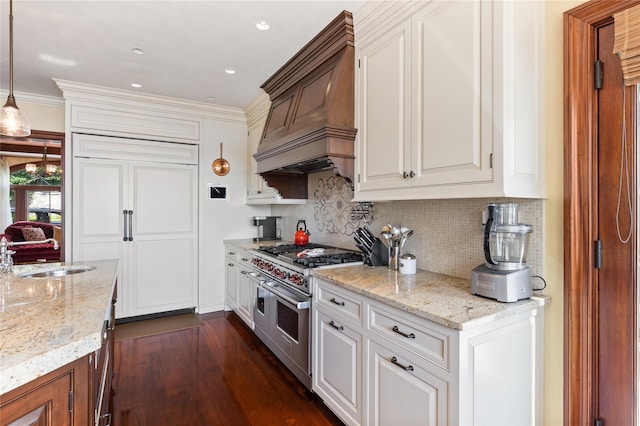 33 Livingston Ave, Dobbs Ferry, NY 10522 - kitchen with range with two ovens, premium range hood, a sink, tasteful backsplash, and light stone counters