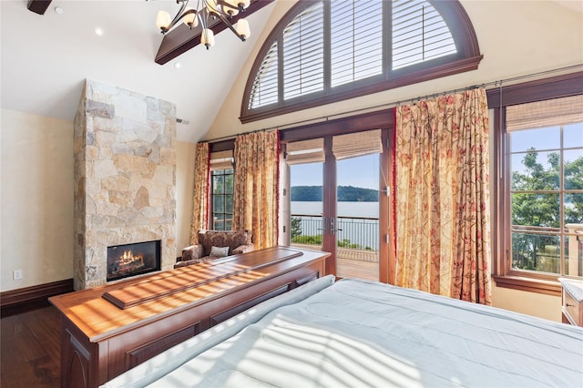 33 Livingston Ave, Dobbs Ferry, NY 10522 - bedroom with a chandelier, access to exterior, high vaulted ceiling, a stone fireplace, and wood finished floors