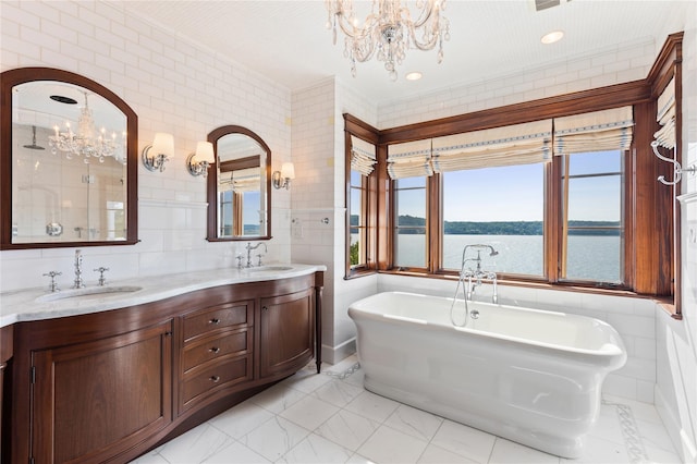 33 Livingston Ave, Dobbs Ferry, NY 10522 - full bath featuring a chandelier, a freestanding bath, double vanity, a water view, and tile walls