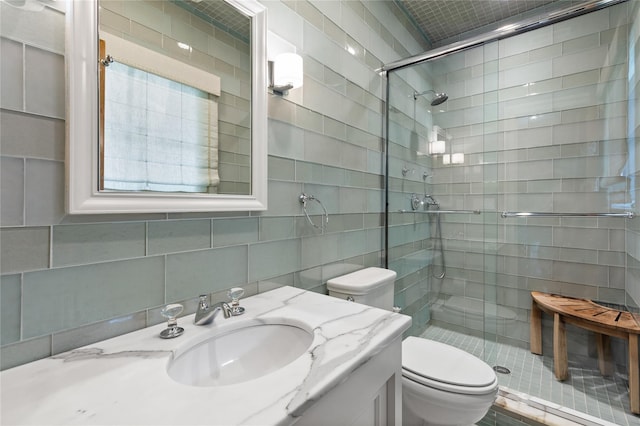 33 Livingston Ave, Dobbs Ferry, NY 10522 - full bath featuring a shower stall, toilet, tile walls, vanity, and decorative backsplash