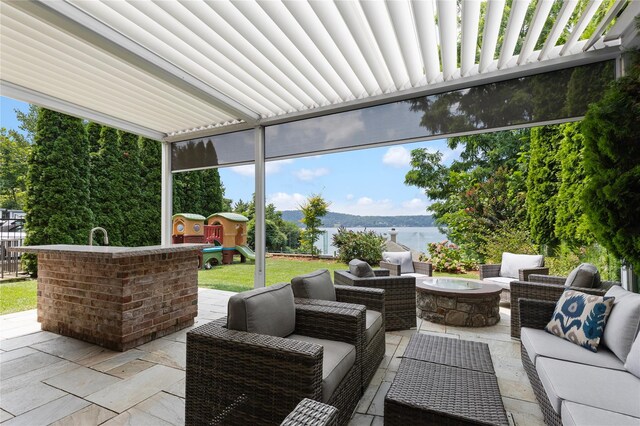 33 Livingston Ave, Dobbs Ferry, NY 10522 - view of patio with an outdoor living space with a fire pit, a playground, and a water view