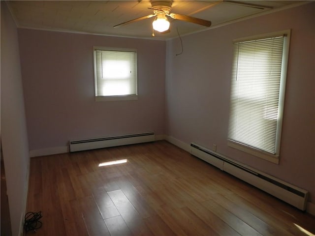 unfurnished room with wood-type flooring, baseboard heating, crown molding, and ceiling fan