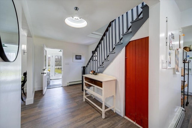 entrance foyer featuring baseboard heating and dark hardwood / wood-style floors