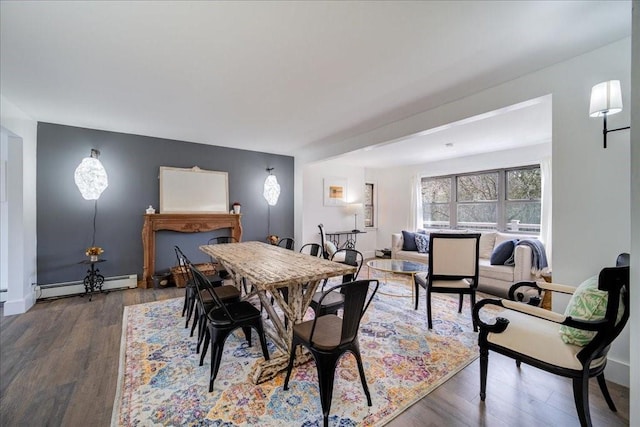 dining room featuring baseboard heating and dark wood-type flooring