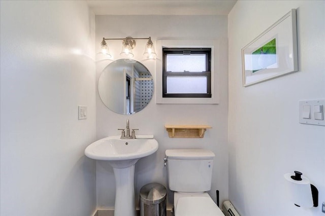 bathroom with a baseboard heating unit and toilet