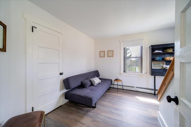 sitting room with hardwood / wood-style floors and baseboard heating