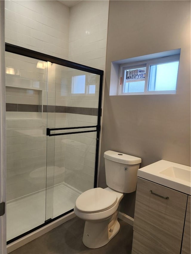 bathroom with vanity, an enclosed shower, and toilet